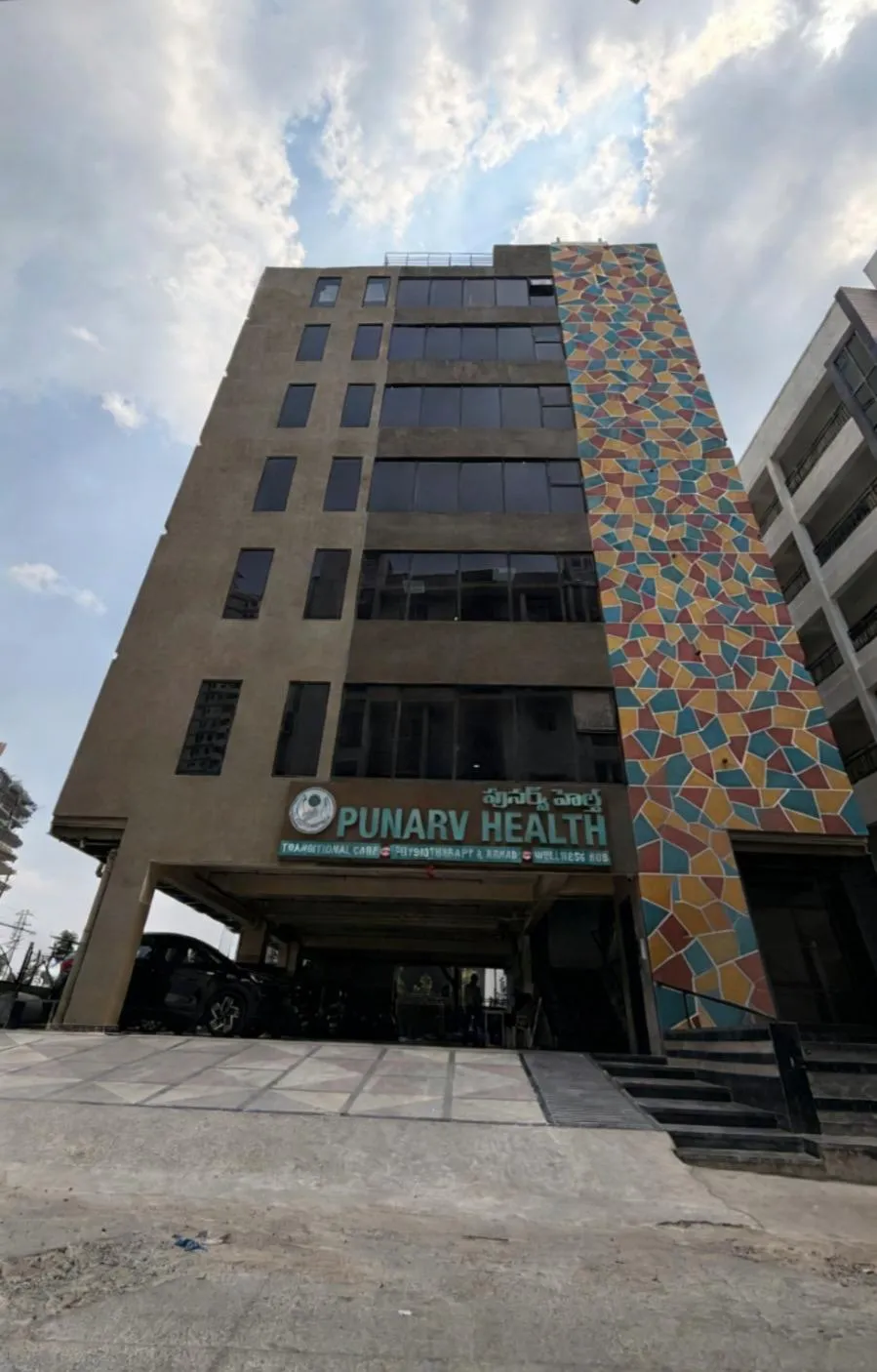 The Punarv Health building exterior, with its mosaic-tile facade